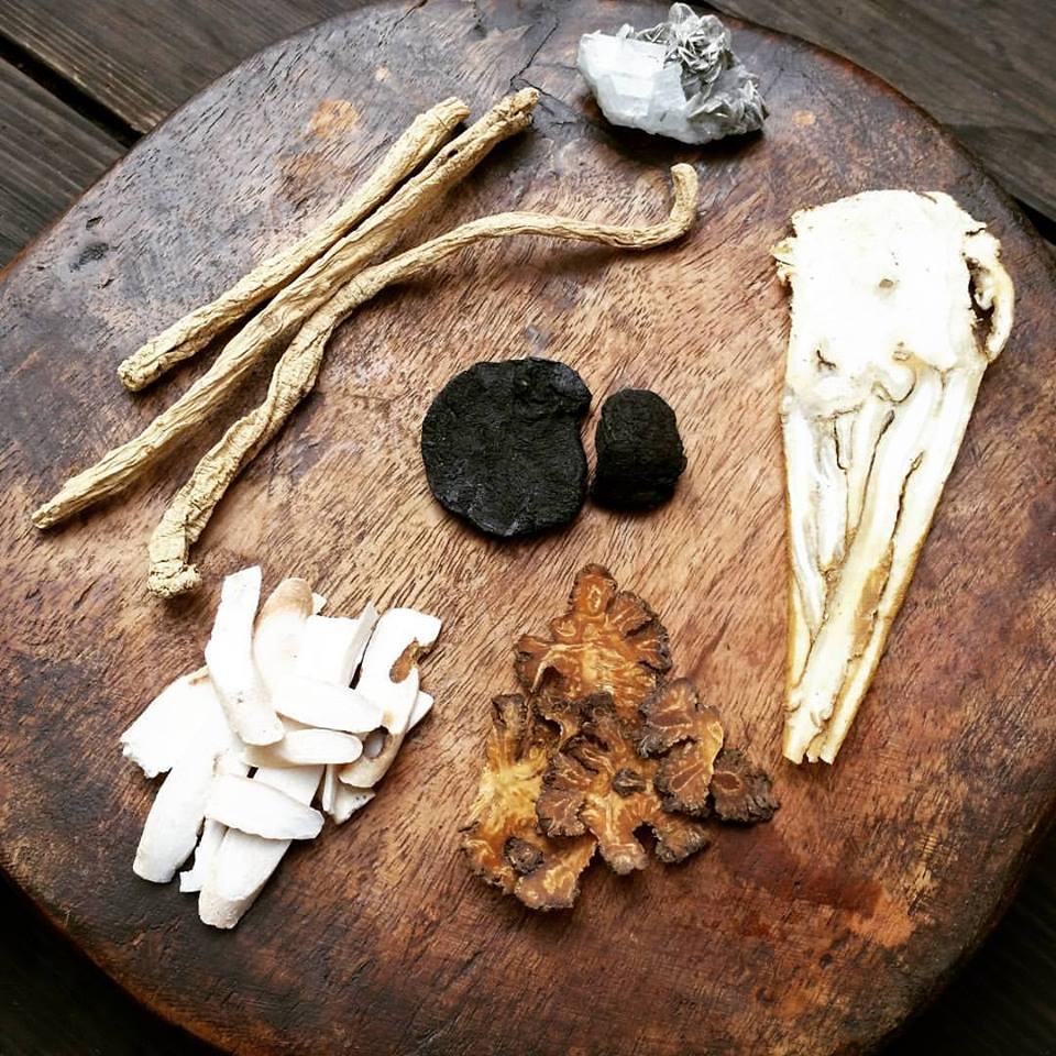 Traditional Chinese herbal ingredients arranged on a wooden table